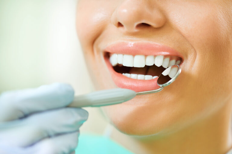 Dentist checking a patient's gum health with a dental mirror